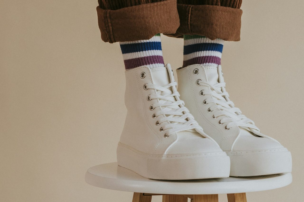 man in white high top shoes standing on chair  DigitalAmy man in white high top shoes standing on chair